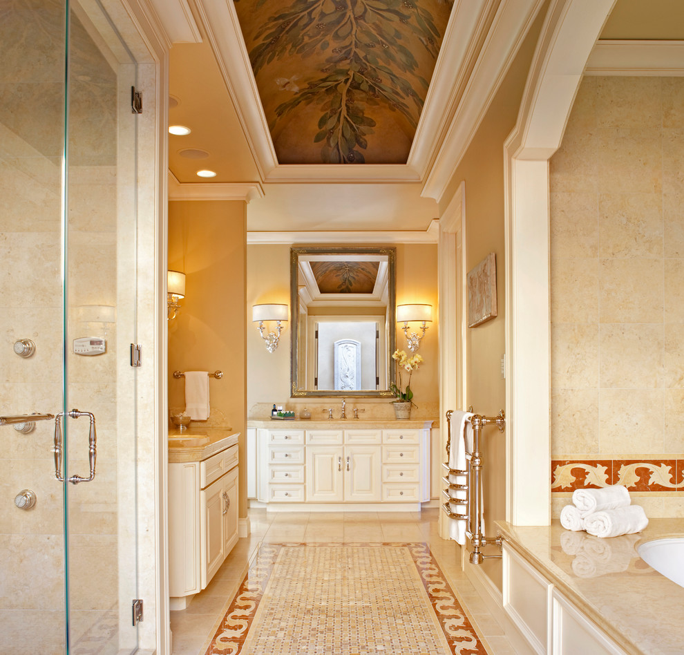 Photo of a large mediterranean ensuite bathroom in San Francisco with a submerged sink, white cabinets, a submerged bath, an alcove shower, a one-piece toilet, beige tiles, beige walls and mosaic tile flooring.