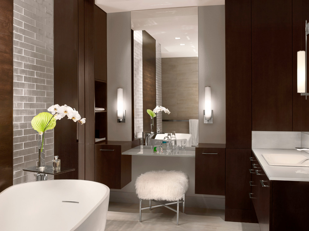 Diseño de cuarto de baño principal contemporáneo con lavabo encastrado, armarios con paneles lisos, puertas de armario de madera en tonos medios y bañera exenta