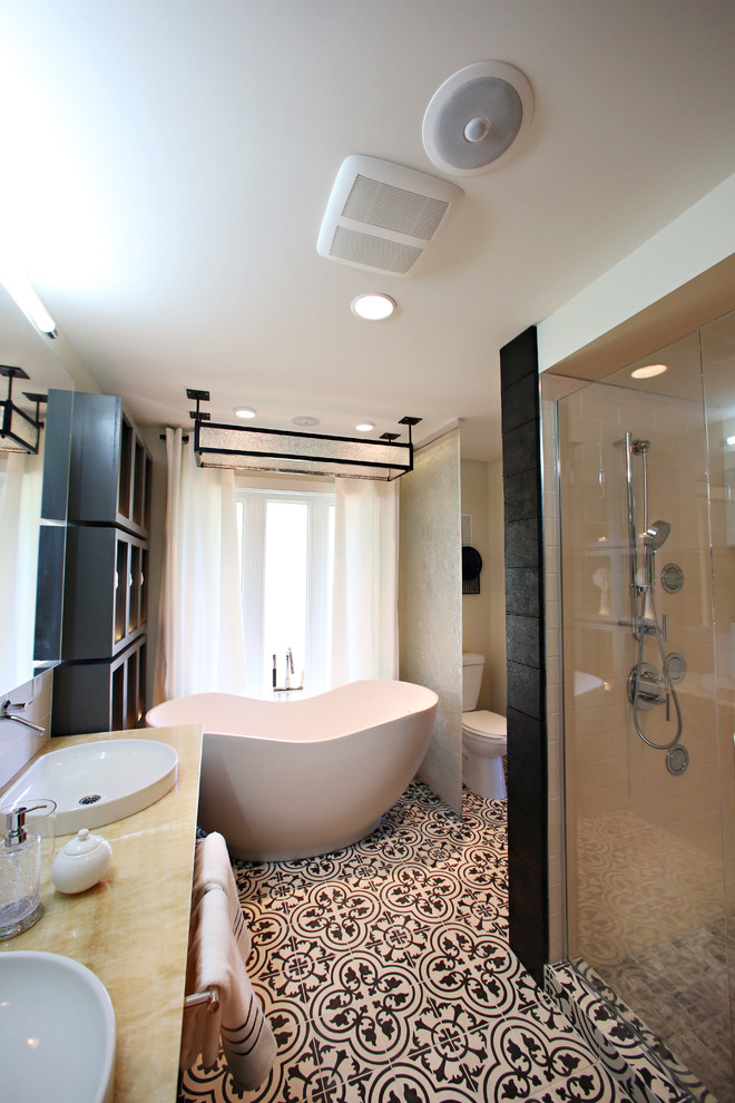 Bathroom - mid-sized transitional master white tile and ceramic tile concrete floor bathroom idea in Minneapolis with a vessel sink, raised-panel cabinets, dark wood cabinets, onyx countertops, a one-piece toilet and white walls