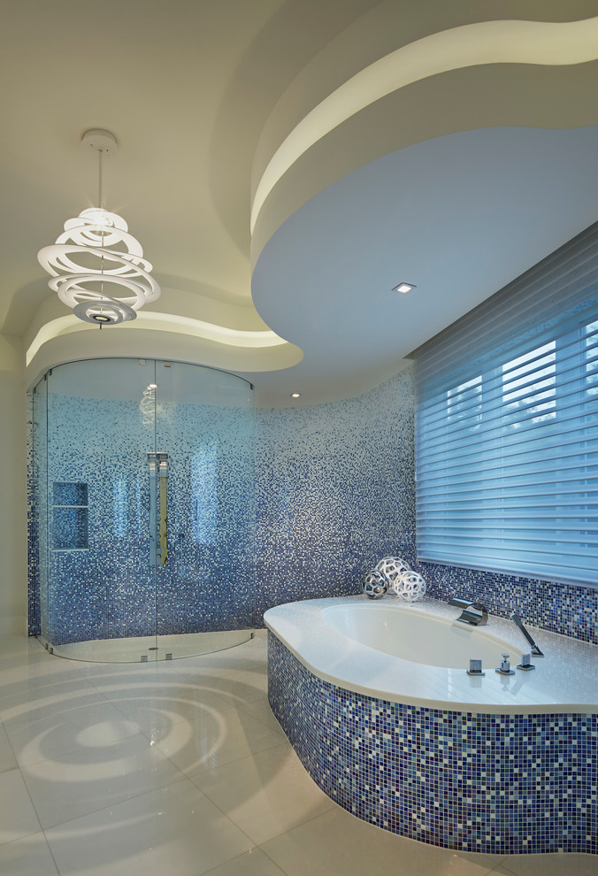 Inspiration for a contemporary bathroom in Miami with a submerged bath, a built-in shower, blue tiles, mosaic tiles and white walls.