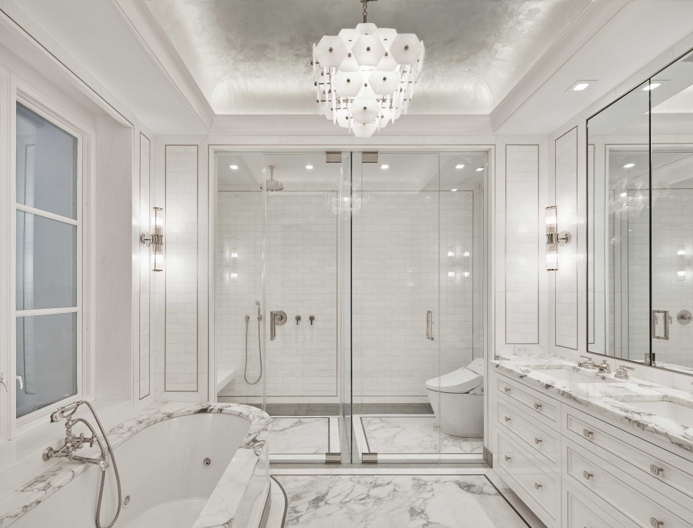 Cette image montre une grande salle de bain principale traditionnelle avec des portes de placard blanches, une baignoire encastrée, une douche ouverte, un carrelage blanc, mosaïque, un mur blanc, un sol en marbre, un lavabo encastré, un plan de toilette en marbre, un sol blanc, une cabine de douche à porte battante, un plan de toilette blanc, un banc de douche, meuble double vasque, meuble-lavabo encastré, un plafond à caissons, du lambris et un placard avec porte à panneau encastré.