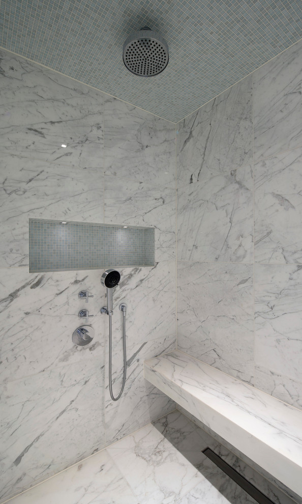 Example of a mid-sized trendy 3/4 stone tile and white tile marble floor doorless shower design in London with white walls