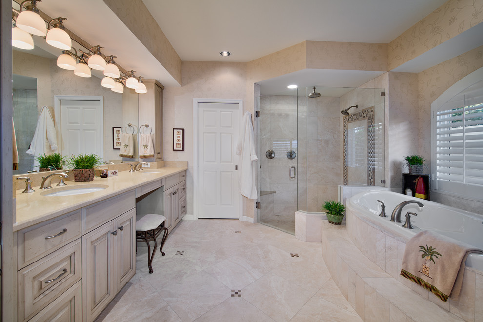 Bathroom - large coastal master beige tile and ceramic tile ceramic tile bathroom idea in Miami with an undermount sink, raised-panel cabinets, distressed cabinets, granite countertops, a two-piece toilet and multicolored walls