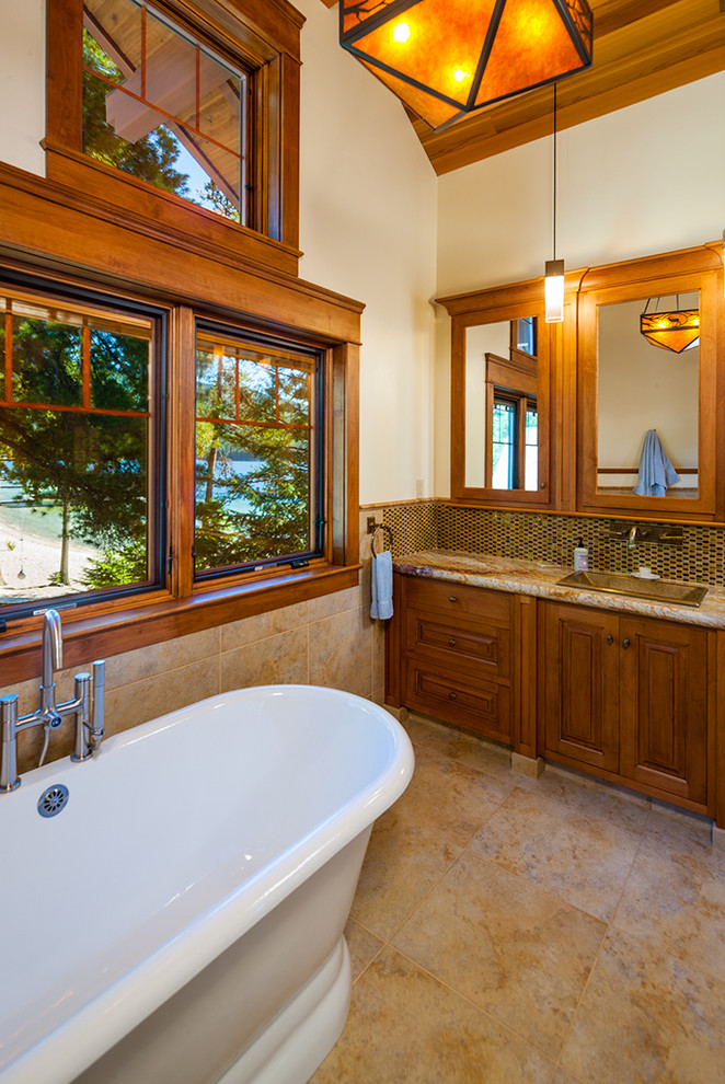 Uriges Badezimmer mit Einbauwaschbecken, profilierten Schrankfronten, hellbraunen Holzschränken, freistehender Badewanne und weißer Wandfarbe in Sonstige