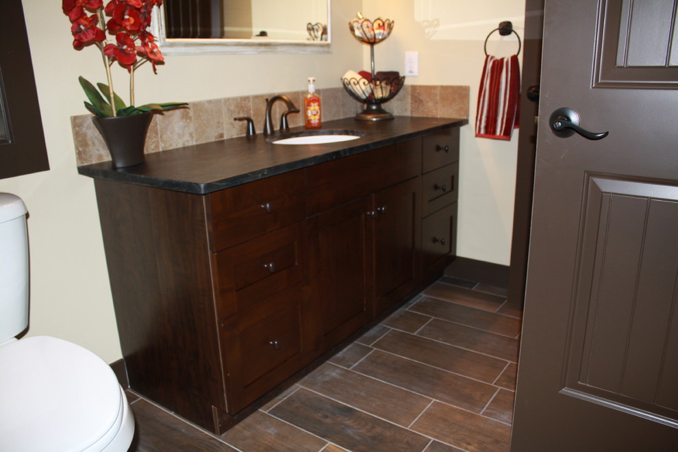 Cette photo montre une salle de bain principale craftsman en bois foncé de taille moyenne avec un placard à porte shaker, un plan de toilette en granite et un sol en carrelage de céramique.