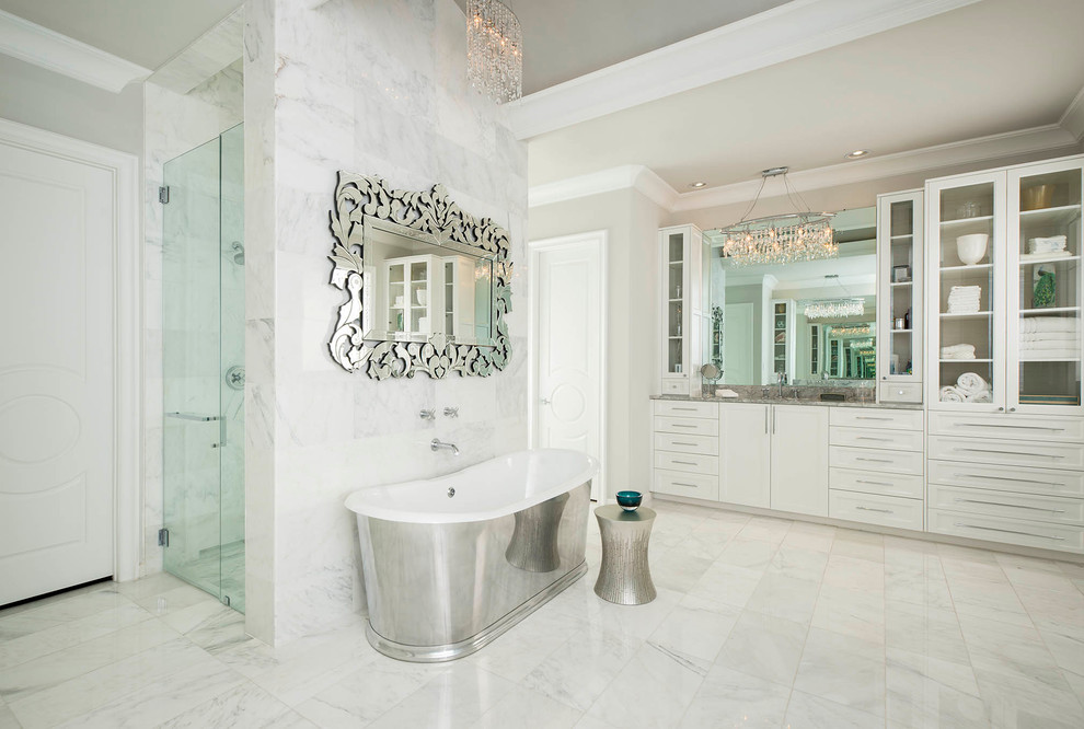 Inspiration for a mediterranean white tile freestanding bathtub remodel in Dallas with shaker cabinets, white cabinets and gray walls