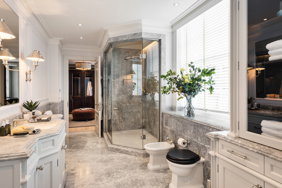 This is an example of a medium sized classic ensuite bathroom in London with a corner shower, white walls, marble flooring, marble worktops, a hinged door, recessed-panel cabinets, white cabinets, a bidet, grey tiles, marble tiles, a submerged sink, grey floors and red worktops.