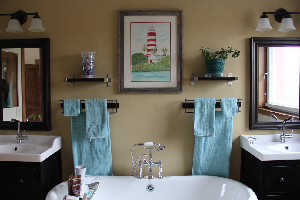 This is an example of a medium sized rural ensuite bathroom in Salt Lake City with a pedestal sink, dark wood cabinets, a claw-foot bath, a corner shower, a one-piece toilet and brown walls.