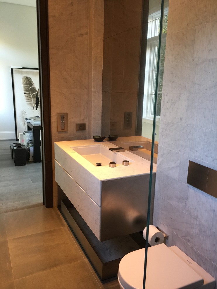 Immagine di una grande stanza da bagno contemporanea con ante lisce, WC monopezzo, pareti multicolore e lavabo integrato