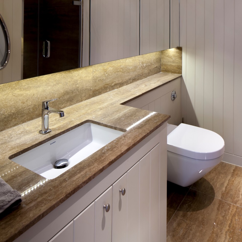Design ideas for a contemporary ensuite bathroom in Gloucestershire with a submerged sink, freestanding cabinets, beige cabinets, a one-piece toilet, white tiles, wood-effect tiles and beige walls.