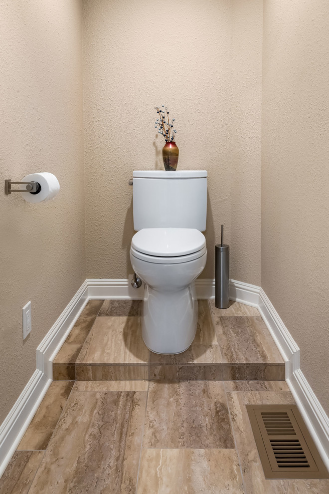 Design ideas for a large contemporary cloakroom in San Francisco with shaker cabinets, dark wood cabinets, a one-piece toilet, beige tiles, porcelain tiles, beige walls, porcelain flooring, a submerged sink, granite worktops and beige floors.
