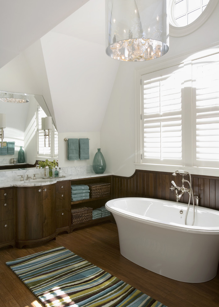 Example of a beach style freestanding bathtub design in Boston with marble countertops