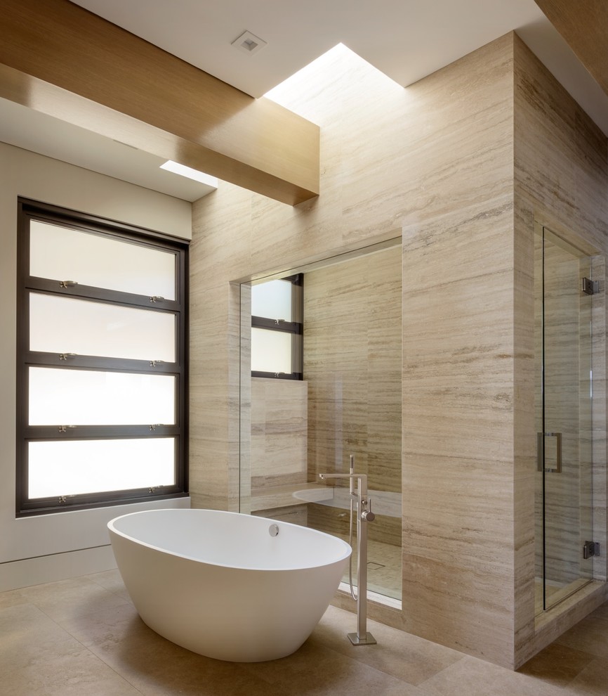 На фото: главная ванная комната в современном стиле с отдельно стоящей ванной, бежевой плиткой, белыми стенами и душем с распашными дверями с