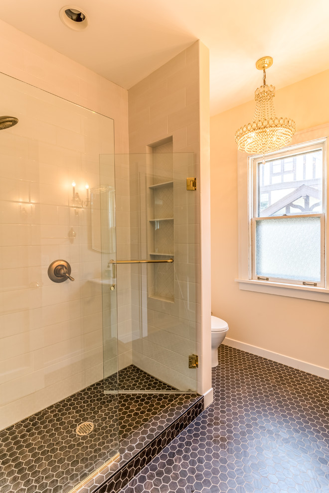 Пример оригинального дизайна: ванная комната среднего размера в стиле неоклассика (современная классика) с душем в нише, унитазом-моноблоком, бежевыми стенами, полом из керамогранита, душевой кабиной, раковиной с пьедесталом, черным полом и душем с распашными дверями