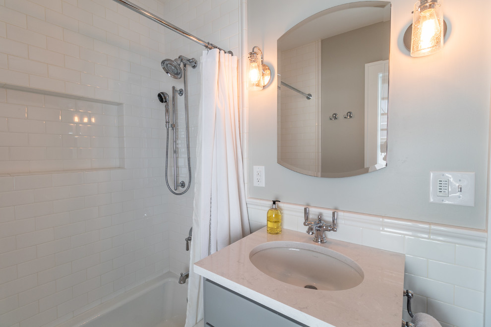 Inspiration pour une douche en alcôve principale traditionnelle de taille moyenne avec un placard avec porte à panneau encastré, des portes de placard grises, une baignoire en alcôve, WC à poser, un carrelage blanc, un carrelage métro, un mur gris, un sol en carrelage de porcelaine, un lavabo encastré, un plan de toilette en quartz modifié, un sol multicolore, une cabine de douche avec un rideau et un plan de toilette blanc.