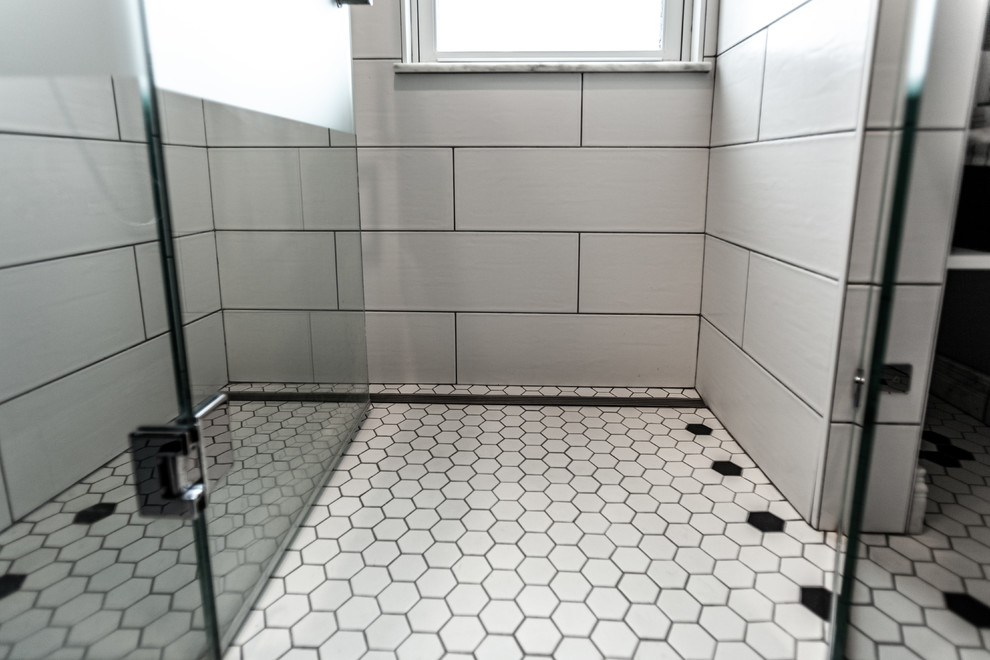 Inredning av ett klassiskt litet grå grått badrum med dusch, med en kantlös dusch, en vägghängd toalettstol, vit kakel, keramikplattor, blå väggar, klinkergolv i porslin, ett undermonterad handfat, bänkskiva i återvunnet glas, vitt golv och dusch med gångjärnsdörr