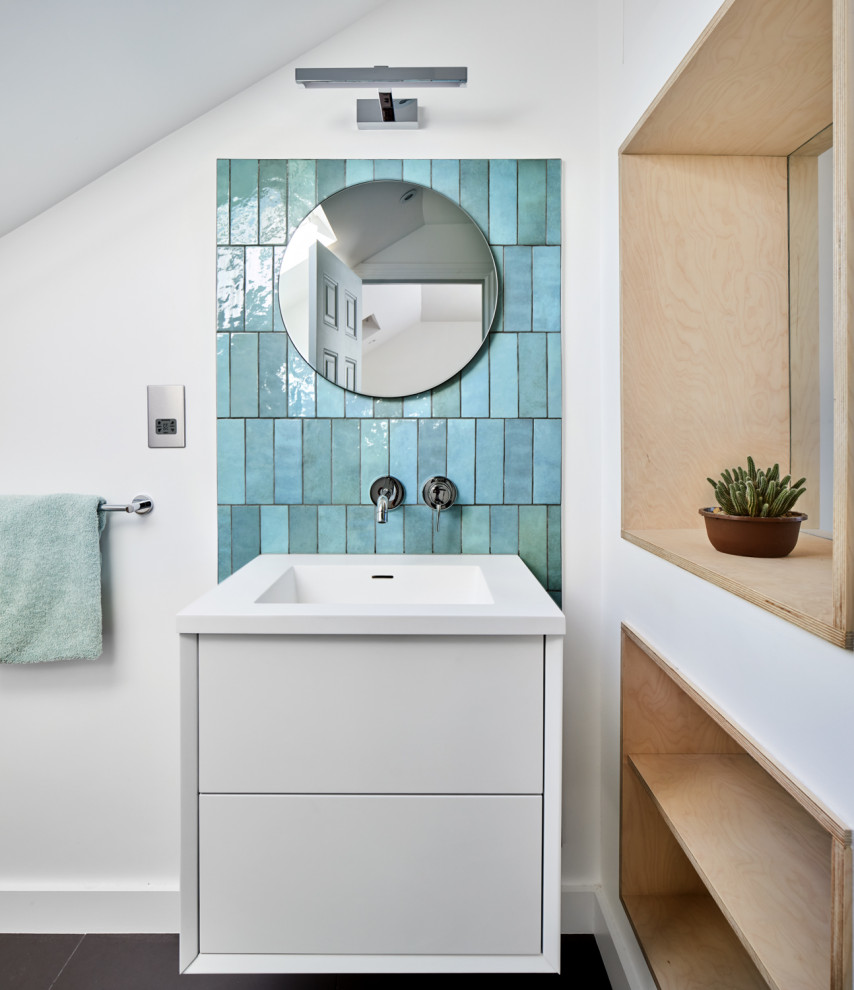 Photo of a medium sized contemporary ensuite bathroom in London with white cabinets, a walk-in shower, a wall mounted toilet, green tiles, ceramic tiles, white walls, porcelain flooring, an integrated sink, white floors, a hinged door, white worktops, a wall niche, a single sink and a floating vanity unit.