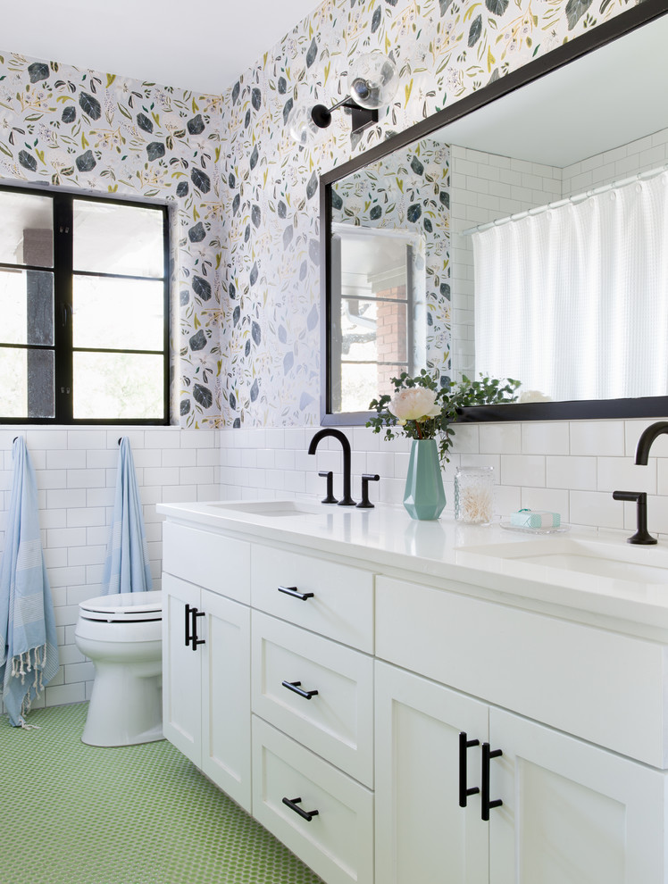 Inspiration for an eclectic bathroom in Austin with shaker cabinets, white cabinets, white tiles, metro tiles, multi-coloured walls, a submerged sink and green floors.