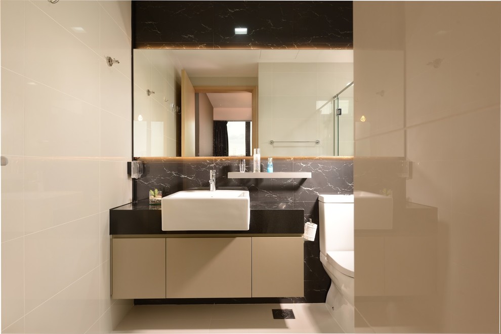 Example of a mid-sized mountain style master black tile and ceramic tile ceramic tile tub/shower combo design in Singapore with a drop-in sink, flat-panel cabinets, beige cabinets, laminate countertops, a one-piece toilet and black walls