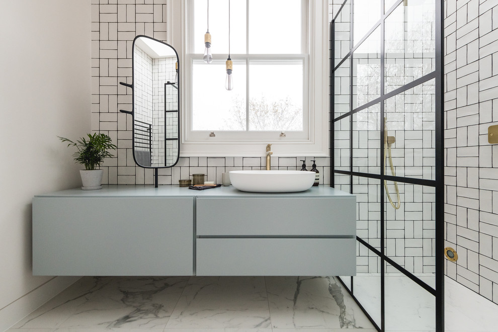 Design ideas for a large contemporary family bathroom in London with flat-panel cabinets, green cabinets, a walk-in shower, white tiles, ceramic tiles, white walls, marble flooring, white floors, an open shower, green worktops and a wall mounted toilet.