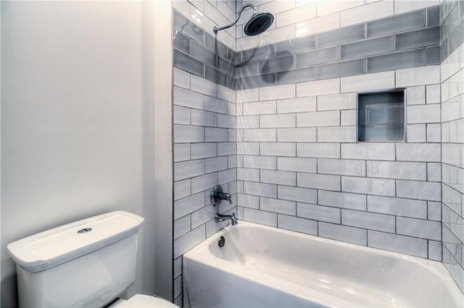 Esempio di una stanza da bagno con doccia chic di medie dimensioni con vasca ad alcova, vasca/doccia, piastrelle nere, piastrelle grigie, piastrelle in gres porcellanato e pareti grigie