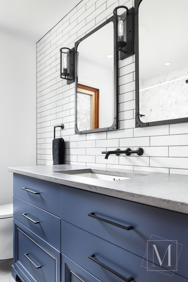 Design ideas for a medium sized urban bathroom in Toronto with flat-panel cabinets, blue cabinets, a shower/bath combination, white tiles, white walls, porcelain flooring, a submerged sink, a shower curtain, grey worktops, grey floors and concrete worktops.