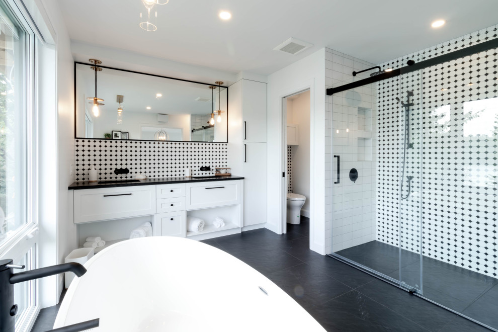 Bathroom - huge transitional master black tile and mosaic tile porcelain tile, black floor and double-sink bathroom idea in Other with shaker cabinets, white cabinets, a one-piece toilet, white walls, an undermount sink, granite countertops, black countertops and a freestanding vanity