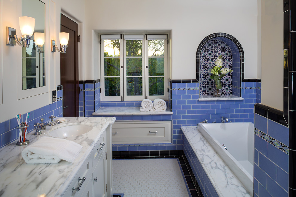 Inspiration for a large mediterranean master blue tile and ceramic tile ceramic tile bathroom remodel in Los Angeles with an undermount sink, shaker cabinets, white cabinets, marble countertops, a two-piece toilet and white walls
