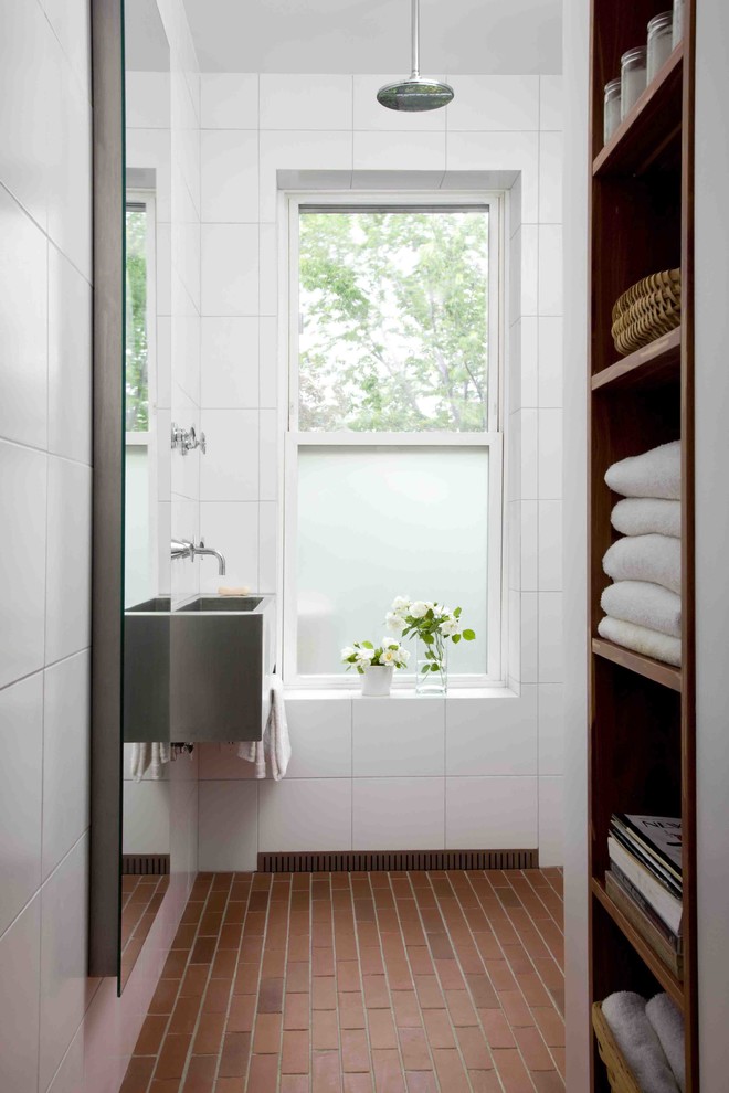 Design ideas for a small contemporary half tiled bathroom in New York with a wall-mounted sink, white walls, open cabinets, stainless steel worktops, white tiles, porcelain tiles, brick flooring, a built-in shower and dark wood cabinets.