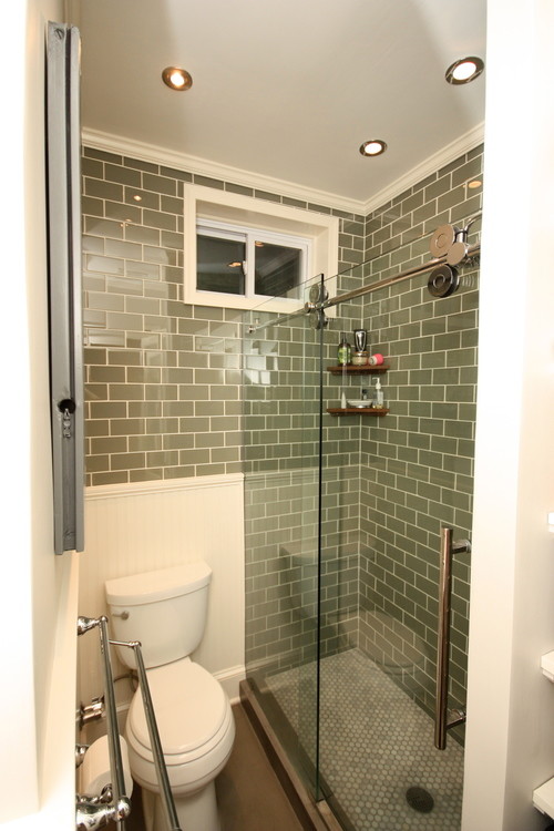 Country subway tile concrete floor alcove shower photo in New York with a two-piece toilet, gray walls and a drop-in sink