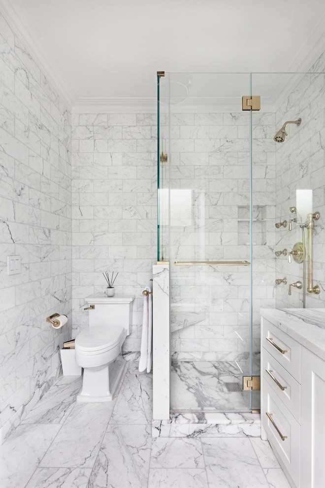 Corner shower - contemporary gray tile, white tile and marble tile marble floor corner shower idea in New York with shaker cabinets, white cabinets, a two-piece toilet, marble countertops, a hinged shower door and white countertops