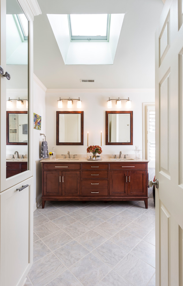 Inspiration for a medium sized traditional ensuite bathroom in Charlotte with a submerged sink, shaker cabinets, medium wood cabinets, marble worktops, an alcove bath, a corner shower, a two-piece toilet, grey tiles, porcelain tiles, beige walls, travertine flooring, grey floors and beige worktops.