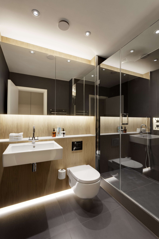Photo of a medium sized contemporary family bathroom in London with open cabinets, white cabinets, an alcove shower, a wall mounted toilet, grey tiles, brown walls, ceramic flooring, a built-in sink, quartz worktops, grey floors, a hinged door, white worktops, a single sink and a built in vanity unit.