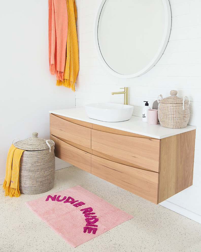 Bathroom - coastal 3/4 concrete floor and beige floor bathroom idea in Sunshine Coast with flat-panel cabinets, light wood cabinets, white walls, a vessel sink and white countertops