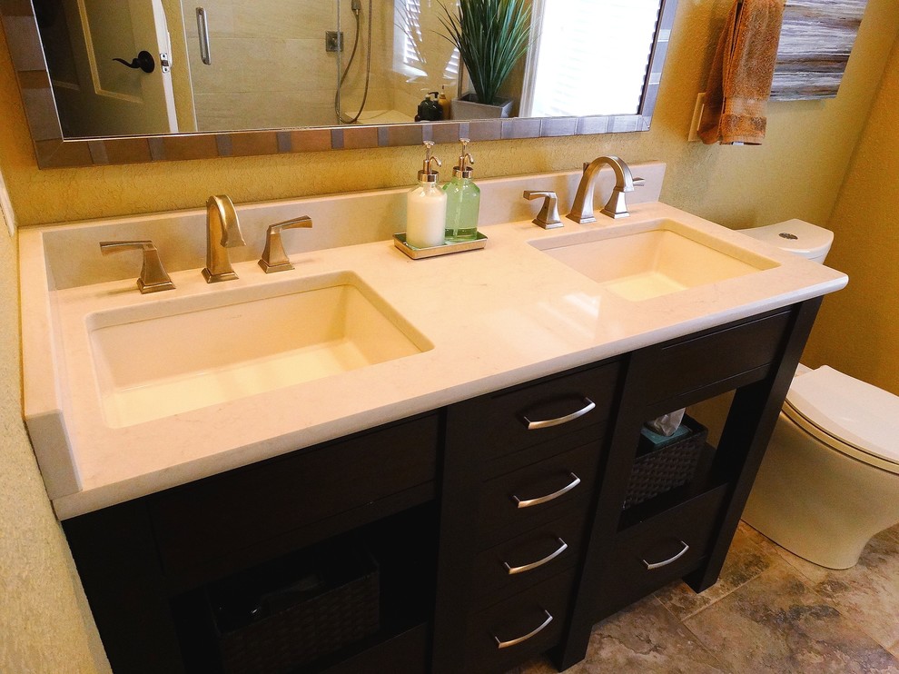 Inspiration for a mid-sized contemporary 3/4 alcove shower remodel in Milwaukee with flat-panel cabinets, black cabinets, a one-piece toilet, beige walls and an undermount sink