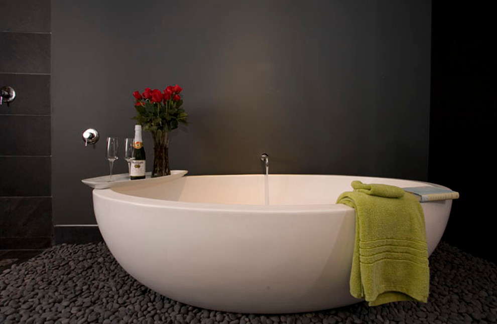 Inspiration for a contemporary pebble tile floor and gray floor freestanding bathtub remodel in Orange County with gray walls
