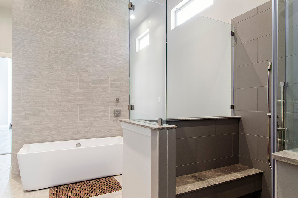 Photo of a large traditional ensuite bathroom in Dallas with a vessel sink, flat-panel cabinets, dark wood cabinets, solid surface worktops, a freestanding bath, a corner shower, a two-piece toilet, grey tiles, porcelain tiles, grey walls and porcelain flooring.