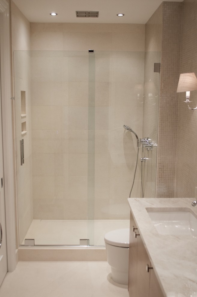 Mid-sized trendy 3/4 beige tile and porcelain tile porcelain tile alcove shower photo in Miami with flat-panel cabinets, light wood cabinets, a one-piece toilet, beige walls, an undermount sink and granite countertops