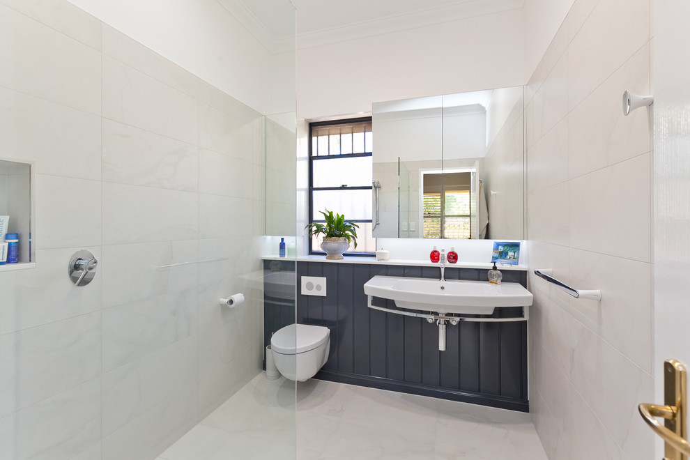 Ejemplo de cuarto de baño contemporáneo con ducha abierta, sanitario de pared, baldosas y/o azulejos beige, paredes blancas, lavabo suspendido y ducha abierta