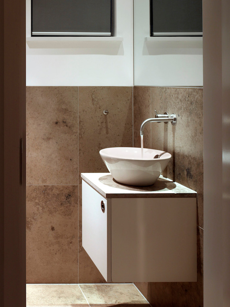 Medium sized contemporary family bathroom in London with freestanding cabinets, white cabinets, a built-in bath, a walk-in shower, a wall mounted toilet, beige tiles, travertine tiles, white walls, travertine flooring, a pedestal sink, quartz worktops and an open shower.