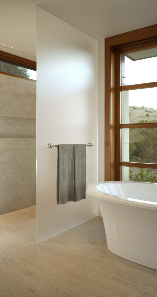 This is an example of a contemporary bathroom in San Francisco with a freestanding bath and a built-in shower.