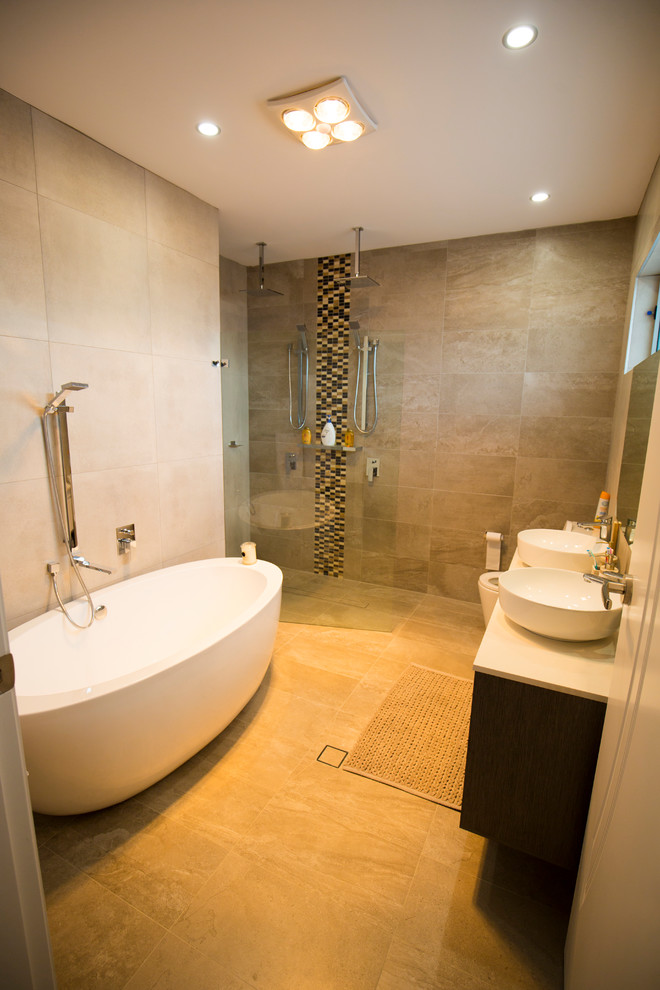 Design ideas for a large modern ensuite bathroom in Sydney with beaded cabinets, dark wood cabinets, a freestanding bath, a double shower, a one-piece toilet, beige tiles, ceramic tiles, beige walls, ceramic flooring, a wall-mounted sink, engineered stone worktops, yellow floors and a hinged door.
