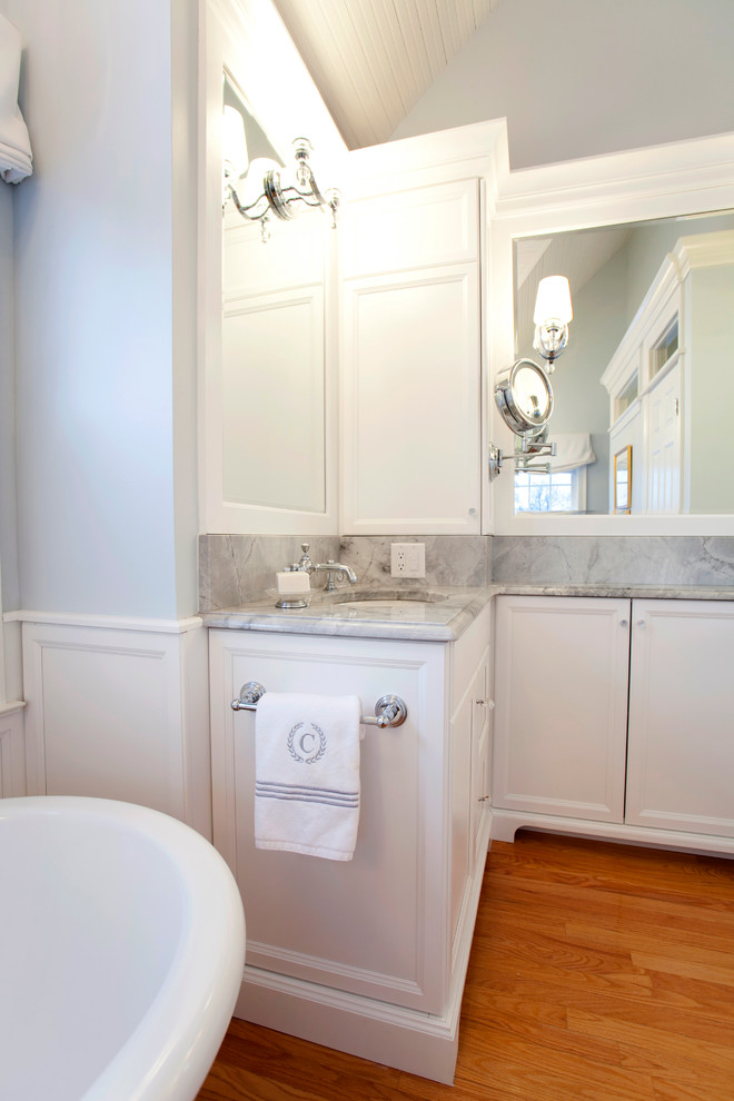 Example of a large classic master medium tone wood floor bathroom design in Bridgeport with an undermount sink, beaded inset cabinets, white cabinets, quartzite countertops and gray walls
