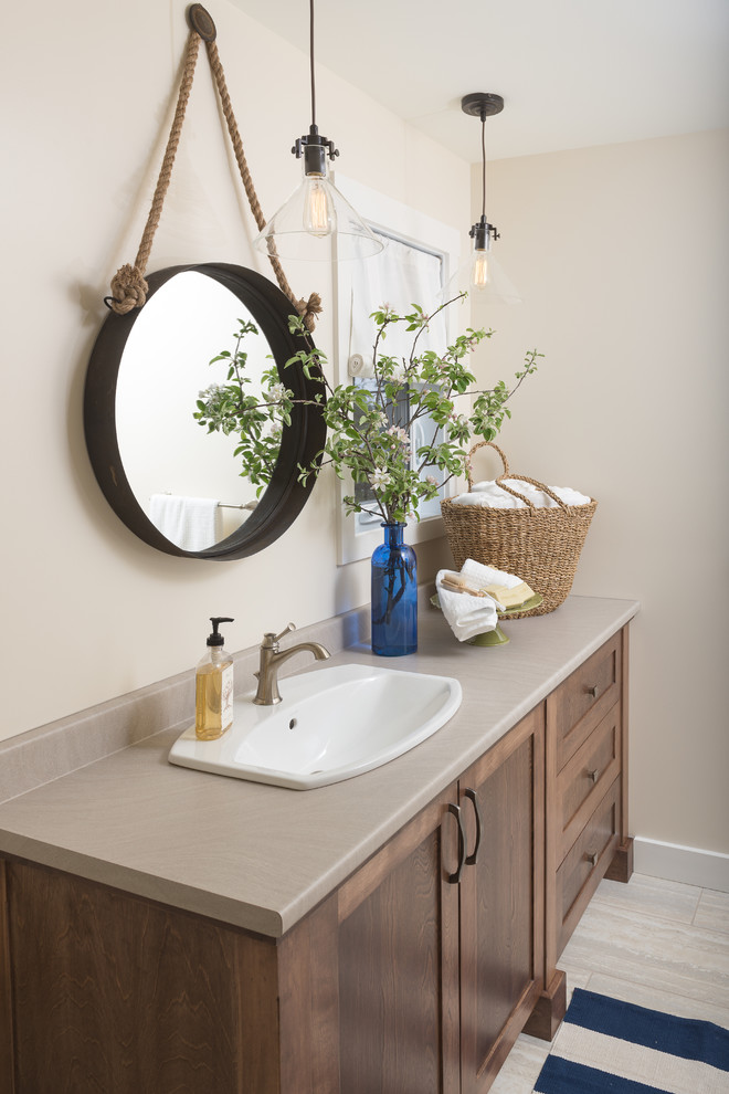 Inspiration for a coastal ceramic tile bathroom remodel in Ottawa with a drop-in sink, shaker cabinets, dark wood cabinets, beige walls and gray countertops