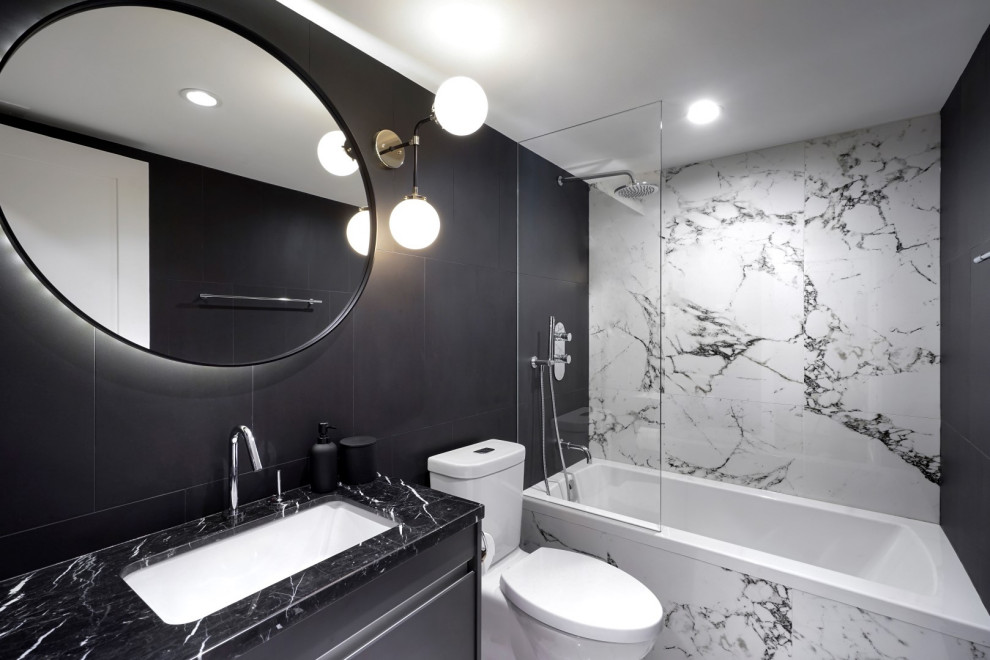 Small contemporary bathroom in Vancouver with flat-panel cabinets, grey cabinets, a built-in bath, a shower/bath combination, a two-piece toilet, multi-coloured tiles, porcelain tiles, black walls, porcelain flooring, a submerged sink, marble worktops, white floors, an open shower and black worktops.