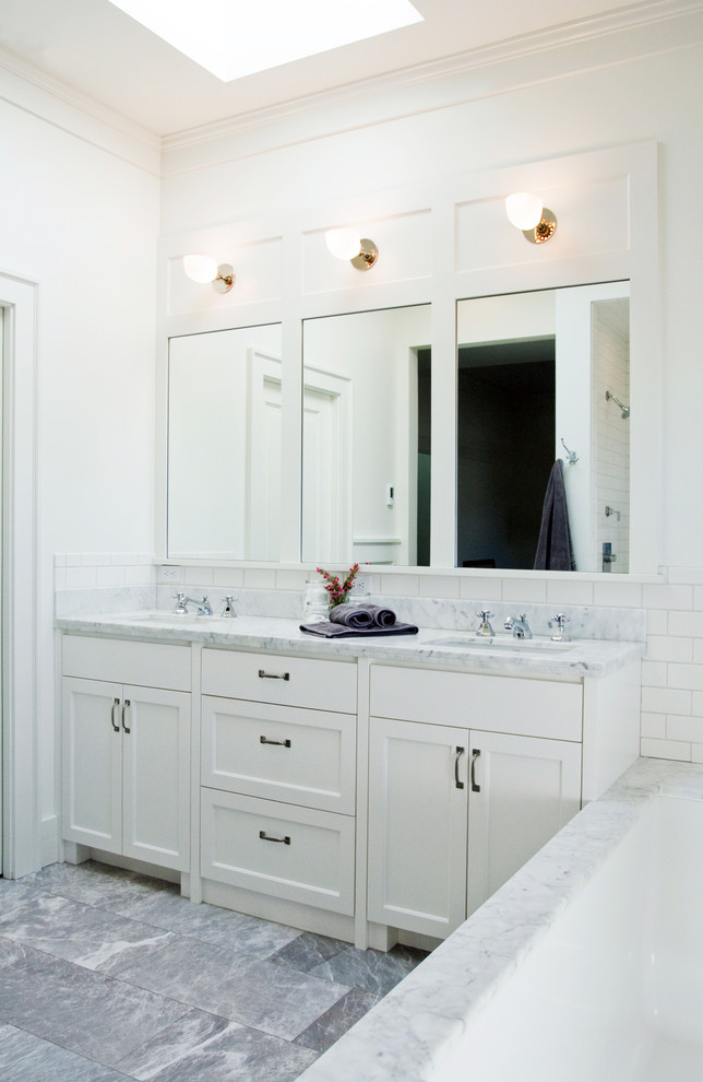 Mid-sized arts and crafts master white tile and ceramic tile marble floor alcove shower photo in Seattle with shaker cabinets, white cabinets, marble countertops, an undermount tub and white walls