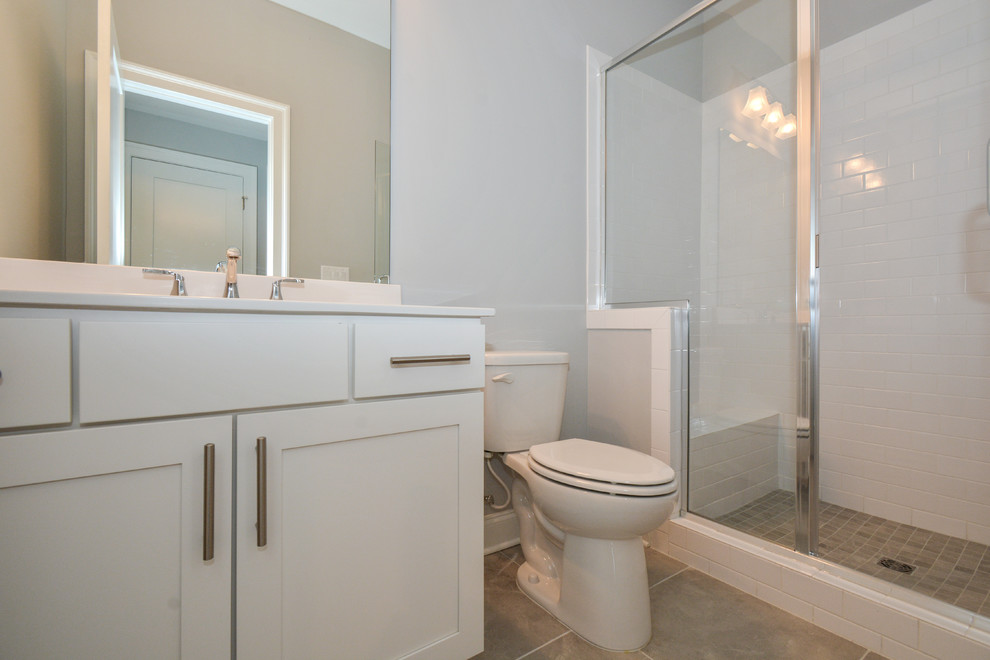 Photo of a medium sized modern ensuite bathroom in Atlanta with shaker cabinets, white cabinets, a walk-in shower, grey walls, a submerged sink, grey floors and an open shower.