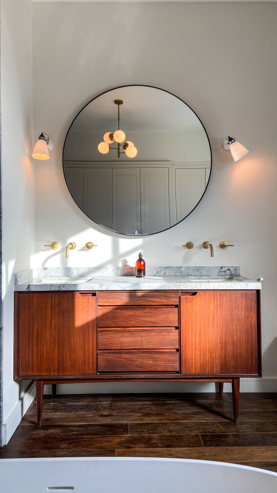 Inspiration for a classic ensuite bathroom in London with flat-panel cabinets, medium wood cabinets, marble worktops, grey worktops, double sinks and a freestanding vanity unit.