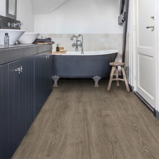 Inspiration for a contemporary bathroom in London with grey cabinets, a claw-foot bath and laminate floors.