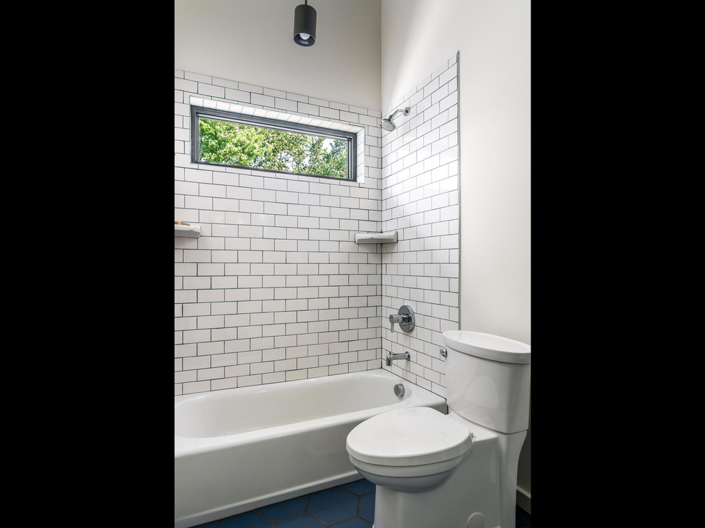 Idée de décoration pour une salle de bain minimaliste de taille moyenne pour enfant avec un placard à porte plane, des portes de placard blanches, une baignoire en alcôve, un combiné douche/baignoire, un carrelage blanc, des carreaux de porcelaine, un mur blanc, un sol en carrelage de céramique, un lavabo intégré, un plan de toilette en quartz modifié, un sol bleu, une cabine de douche avec un rideau et un plan de toilette blanc.